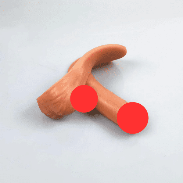 A realistic silicone prosthetic of the male genitalia with a visible curve, displayed on a plain white surface. Labeled as the MRIMIN Cheap Soft Packer in Ivory & Beige, the image is partially censored with two red dots covering specific areas for modesty.