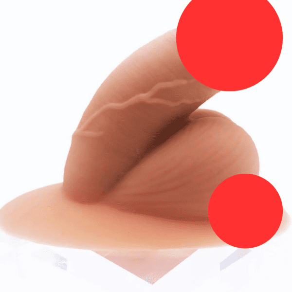 A silicone prosthetic p*nis, resembling that of a Caucasian, is displayed on a transparent stand. Two red circles partially obscure the image. The prosthetic p*nis features a detailed and realistic texture. The background is white, highlighting the color and details.