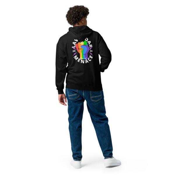 A person in a black unisex hoodie and blue jeans stands with their back to the camera. The zip hoodie features a colorful fist logo and the words "LAID BACK MENACE 2024" in a circular design.